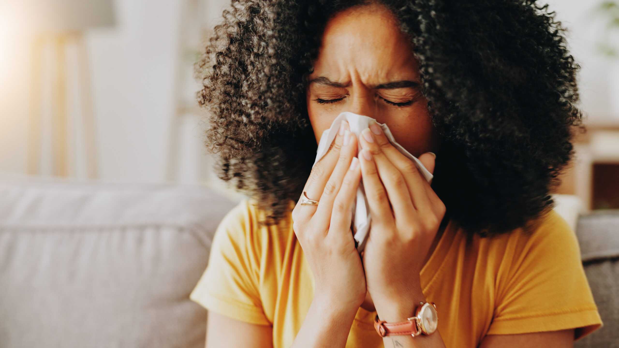 mulher espirrando, com alergia ao frio